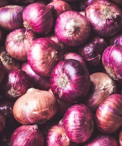red onion on brown wooden table